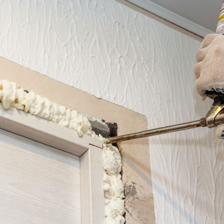 Topsen A1 PU foam applied to seal gaps between a door frame and wall, providing insulation and airtight sealing.